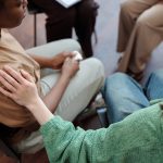 Girl comforting friend during session